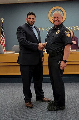 Police Chief Smith shaking hands with employee