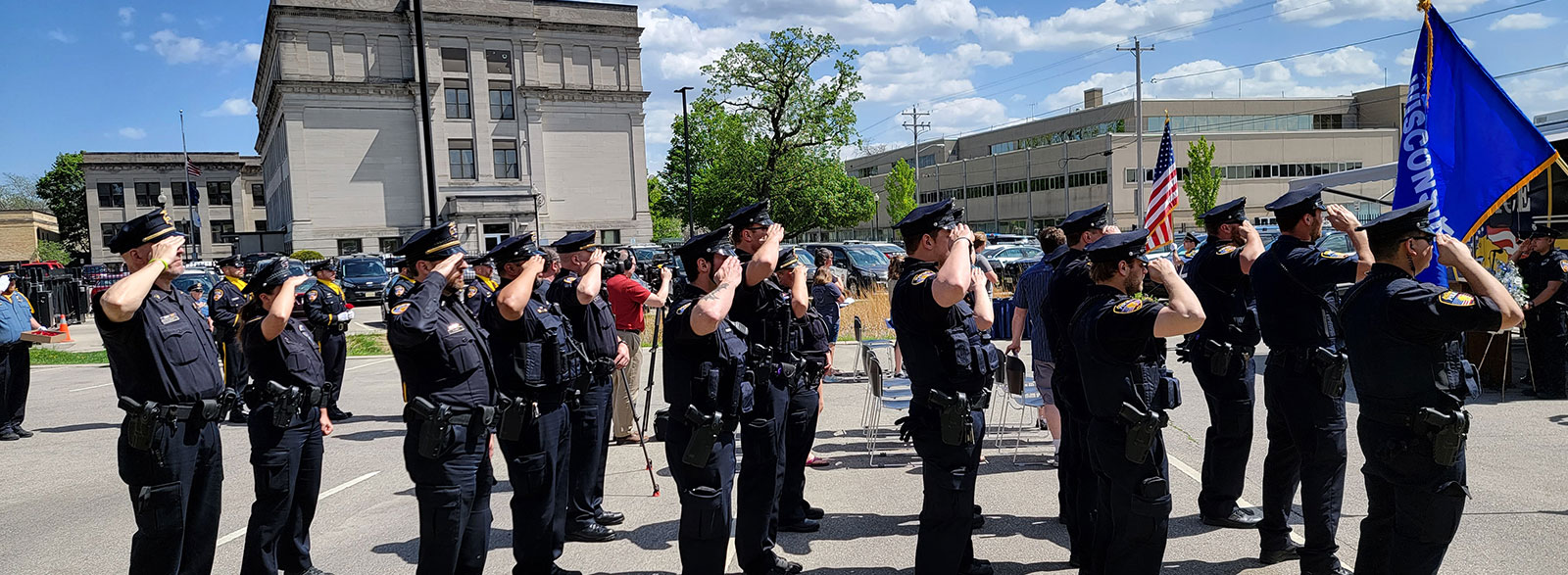 Officers standing by squad cars