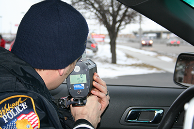 Officer uses radar to look for speeders